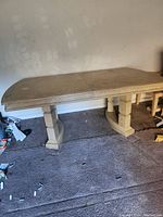 Vintage wooden dining table viewed from above showing rectangular shape with rounded edges and seam down the middle.