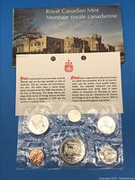 The original 1974 Royal Canadian Mint packaging with six sealed coins and commemorative envelope visible.