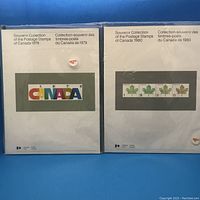 Front view of the 1979 and 1980 Canada Post souvenir collection booklets showing their covers with year and graphic designs, both still sealed in plastic.