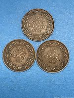 Reverse side showing the "ONE CENT CANADA" text surrounded by a border of maple leaves on three Canadian large cents from 1916, 1917 and 1920, displayed on a light background.