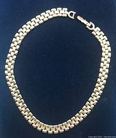 Full view of the Monet silver tone necklace laid flat showing the clasp and the chain pattern.