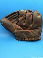 Top side view of brown leather baseball glove showing glove fingers and palm area