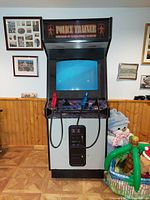 Full front view of Police Trainer cabinet showing marquee, CRT screen, control panel with guns and coin door