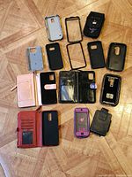 Top-down view of 12 various Samsung Galaxy phone cases, including wallet-style and protective covers in multiple colors.