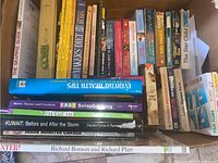 Photo showing the variety of books from different genres and formats, including hardbacks and paperbacks, arranged within a single box.