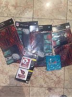 Photo showing 5 football-themed table covers, one package of napkins, and the vertical flag packaging.