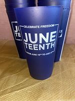 Blue plastic cups with white text 'Celebrate Freedom June Teenth from June 19th to July 4th' displayed in photo to show commemorative design.