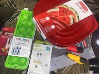 Photo showing Kolorae silicone 14 ball ice tray, Rubbermaid red take-along bowl with lid featuring watermelon design, Caspian olive appetizer pick set, two magnetic clips (yellow and dark gray), and GoodCook turkey pop-up timers.
