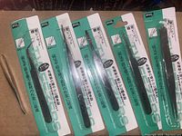 Photo showing six tweezers, five in original packaging and one without packaging, various styles and sizes.