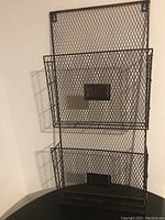 Front view of the two-tier black wire filing rack showing mesh wire design and label holders.