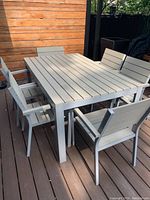 Full view of rectangular table and six chairs on deck