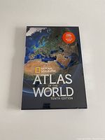 Front cover of the sealed National Geographic Atlas of the World Tenth Edition showing the globe focusing on Europe and Africa.
