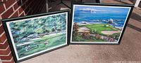 Two framed prints shown outdoors leaning against wall, depicting Pebble Beach golf scenes.