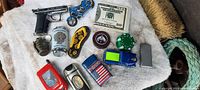 Overview of 14 assorted novelty pocket lighters in toy and unusual shapes arranged on a white surface.
