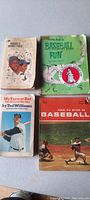 Photo showing four vintage baseball publications arranged side by side revealing covers and titles.