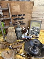 Wooden crate and all contents with various vintage collectibles including books, broom, jug, wooden molds, and candle holder