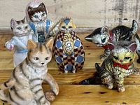 Front view showing all six collectible cat figurines, highlighting a variety of styles and colors.