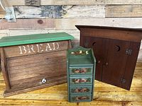 Photo showing all three items: bread box, outhouse shape box, hanging cabinet