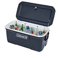 Blue Coleman hard chest cooler open showing interior filled with ice and assorted bottles and cans.