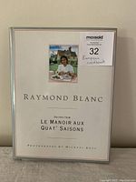 Front cover of the Raymond Blanc cookbook featuring the title and a photo of Raymond Blanc at the restaurant.
