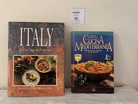 Both cookbooks shown side by side: 'Italy: A Culinary Journey' with rustic cover on left, 'La Cucina Mediterranea' with vibrant pasta bowl cover on right.