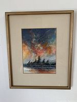 Full view of the framed watercolour painting showing the sunset scene with silhouetted islands and clouds.