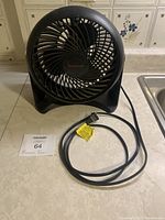 Front view of the Honeywell HT900C room fan showing the circular grille, blades, base, and power cord.