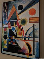 Full view of the Kandinsky print showing varied geometric shapes, colors, and black frame