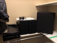 CD receiver and three speakers on shelf