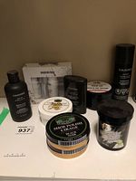 Photo of various leather care products including Danier liquid leather cleaner, saddle soap, black shoe polish, leather lube, horse hair brushes, and Birkenstock care kit.