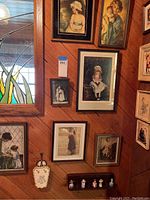 Wall display showing 7 framed vintage-style artworks depicting children and pastoral scenes, and a set of 5 collectible thimbles on a small wooden holder.