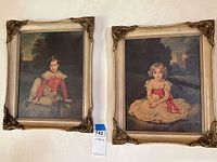 Two framed prints side by side on a textured wall, showing the full view of each artwork and its gold-tone ornate frame.