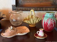 Photo showing all six items: crackle glass vase, yellow flower basket, red and turquoise flower pot vase, miniature pitcher, ashtray, and commode.