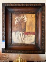 Full view of the framed metal wall art painting showing the ornate metal frame and floral painting.