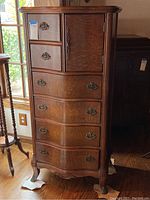 Full front view of dresser showing six drawers, right-side cabinet door, cabriole legs