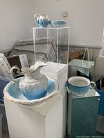 Full set of ceramic washstand items including pitcher, wash basin, chamber pot, and soap dish.