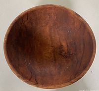 Top view of the large wooden bowl showing circular shape and wood grain.