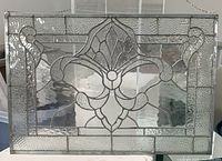 Full front view of the rectangular clear glass panel with leaded decorative motif