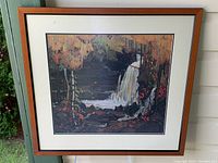 Framed art print showing the full image with waterfall, trees, rocks, and foliage.