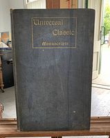 Front cover of the book titled 'Universal Classic Manuscripts' in gold lettering on a slate blue cloth cover.