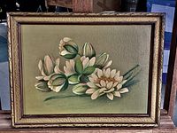 Frontal view of the framed oil painting showing white flowers and green buds against a green background.