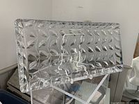 Side angled view of clear rectangular cut crystal tray showing intricate deep cut leaf pattern and thickness of crystal.