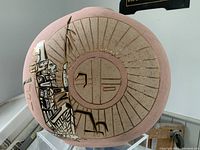 Front view of the large pottery vase showing West Coast design motifs and circular sunray element.