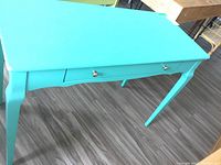 Top angle view of the turquoise painted wood hall table showing drawer and silver knobs.