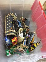 Bin top view displaying a large collection of Lego pieces including castle sections, minifigures, and accessories related to Harry Potter theme.