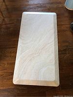 Full view of rectangular anti-fatigue kitchen mat on wooden floor, showing beige marbled pattern and rectangular shape.