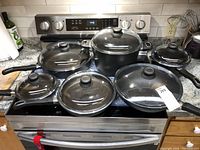 Full set of Gastrolux nonstick cookware including various pots and pans on a stove.