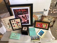 Full view of collection showing framed advertisements and memorabilia related to mermaids and marketing ads.