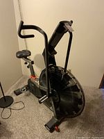 Front-side view showing overall frame, fan wheel, seat and handlebars