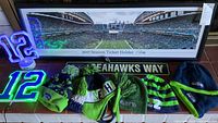 Full lot with framed panoramic stadium poster, 4 Seahawks hats, neon 12 lights, and street sign laid out on floor